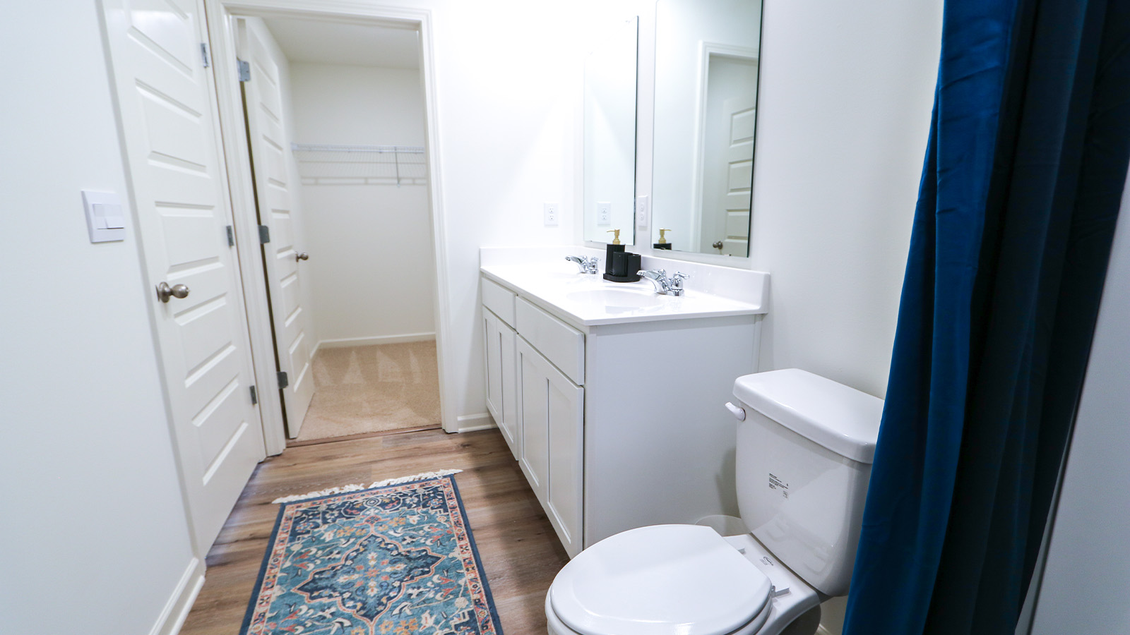 A spacious double vanity with mirrors is available. The vanity features ample space and two mirrors for convenience.