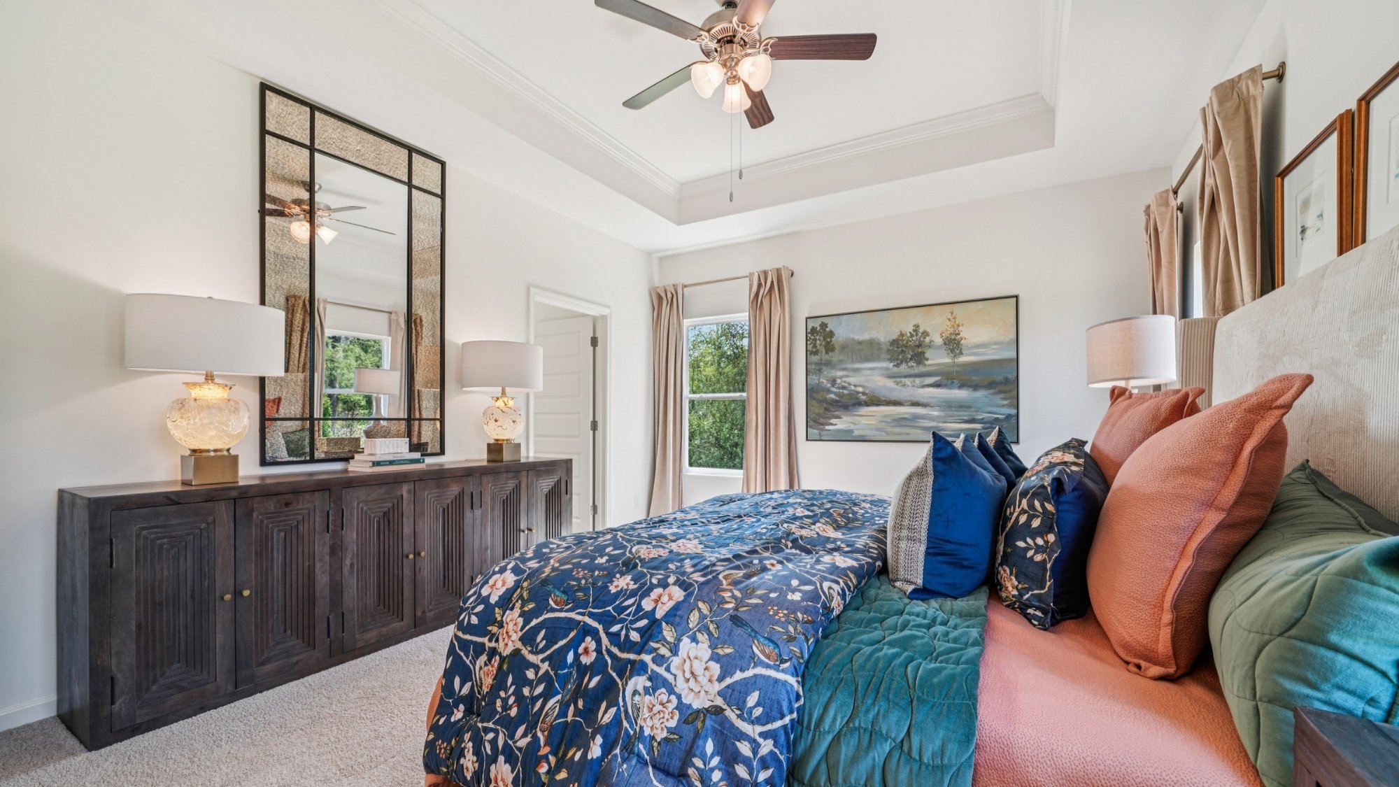 The spacious primary bedroom features a large king bed and two nightstands. Additionally, there is a sizable double window offering a view of the backyard.   The large primary bedroom shows off ample space with a large king bed, 2 nightstands and a large double window that overlooks the backyard.