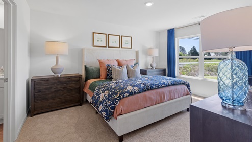 The spacious primary bedroom features a large king bed and two nightstands. Additionally, there is a sizable double window offering a view of the backyard. The large primary bedroom shows off ample space with a large king bed, 2 nightstands and a large double window that overlooks the backyard.