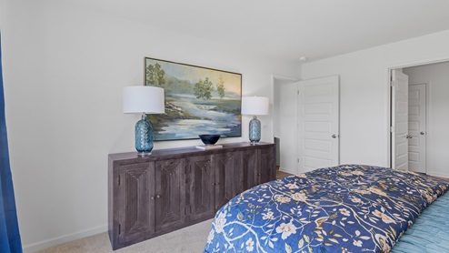 The spacious primary bedroom features a large king bed and two nightstands. Additionally, there is a sizable double window offering a view of the backyard. The large primary bedroom shows off ample space with a large king bed, 2 nightstands and a large double window that overlooks the backyard.