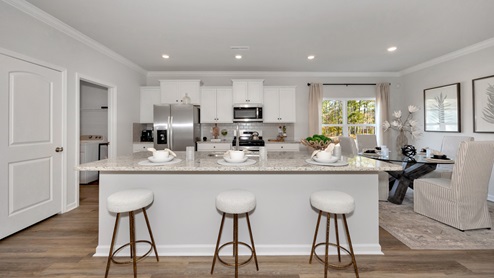 Kitchen island with painted cabinets and stainless steel appliances
