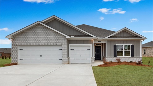 Single story home with brick and three car garage