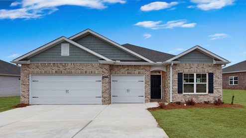 Single story home with brick and three car garage