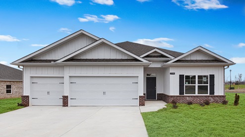 Single story home with brick and three car garage