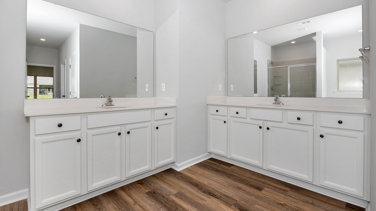 Primary bath with painted cabinets and quartz countertops
