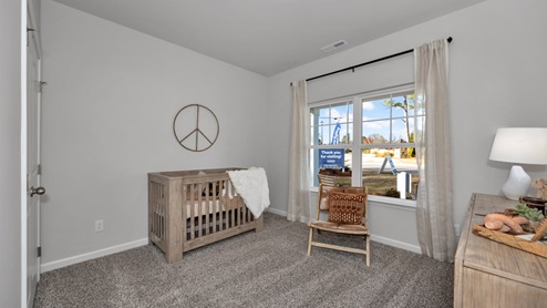 Secondary bedroom with carpet and window
