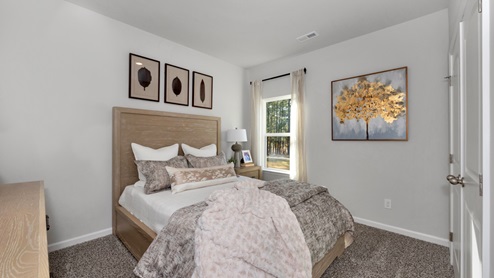 Secondary bedroom with carpet and window