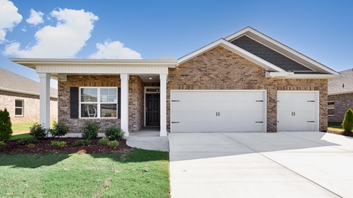 Single story home with brick, covered porch and three car garage