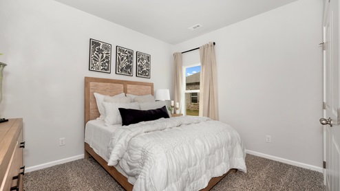 Secondary bedroom with carpet and window
