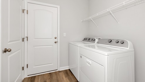 Laundry room with wire shelf and washer dryer hook up