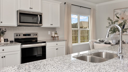 Kitchen sink with granite surround and stainless steel appliances