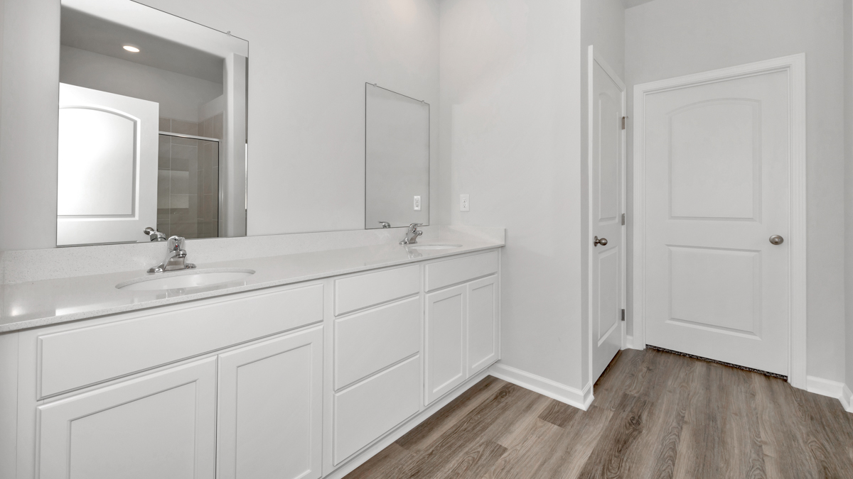 Primary bath with painted cabinets and quartz countertops