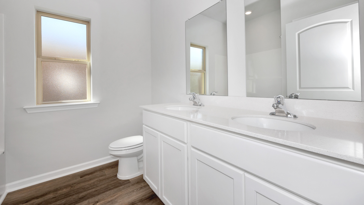 Secondary bathroom with painted cabinets and quartz countertops
