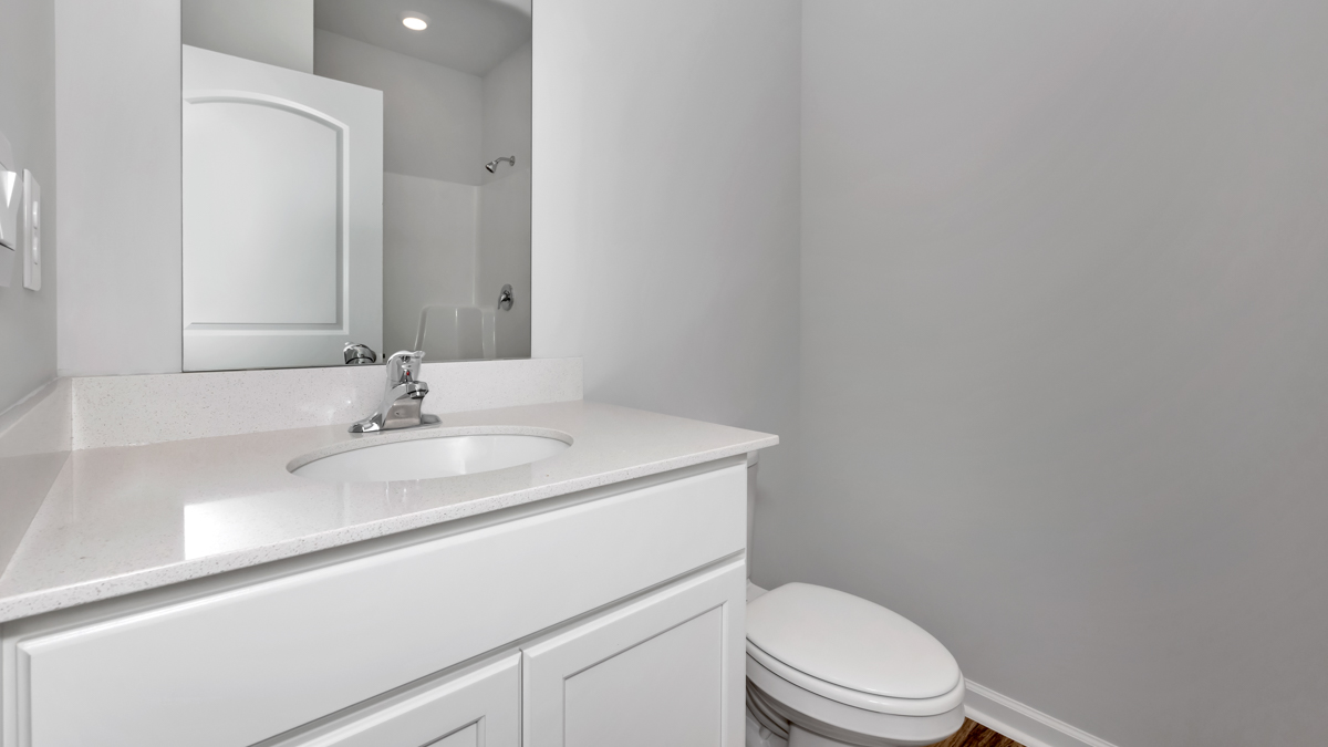 Secondary bathroom with painted cabinets and quartz countertops
