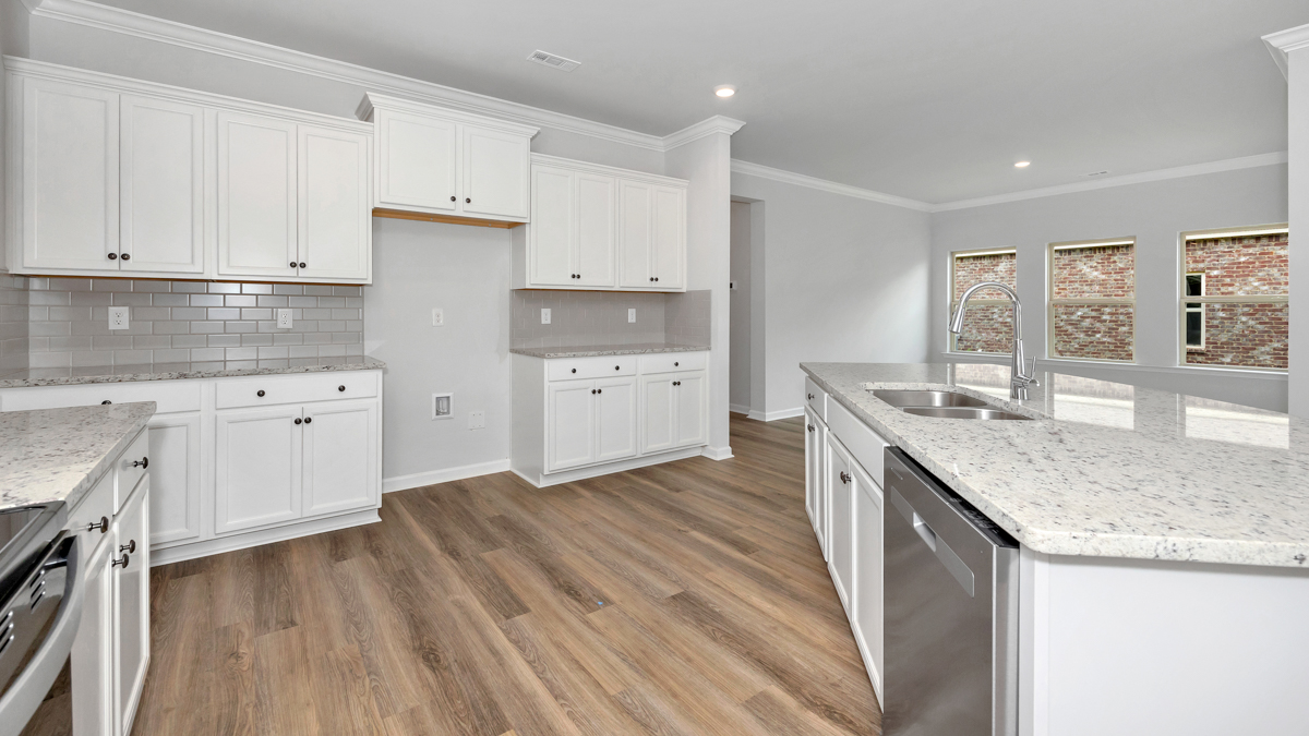 Kitchen island with painted cabinets and stainless steel appliances