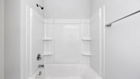 Secondary bathroom with painted cabinets and quartz countertops