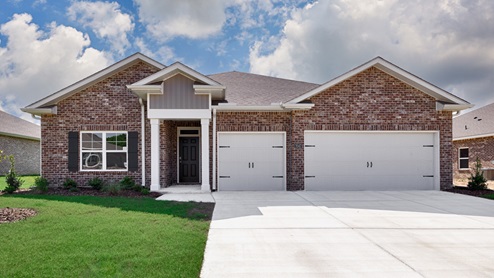 Single story home with brick and three car garage