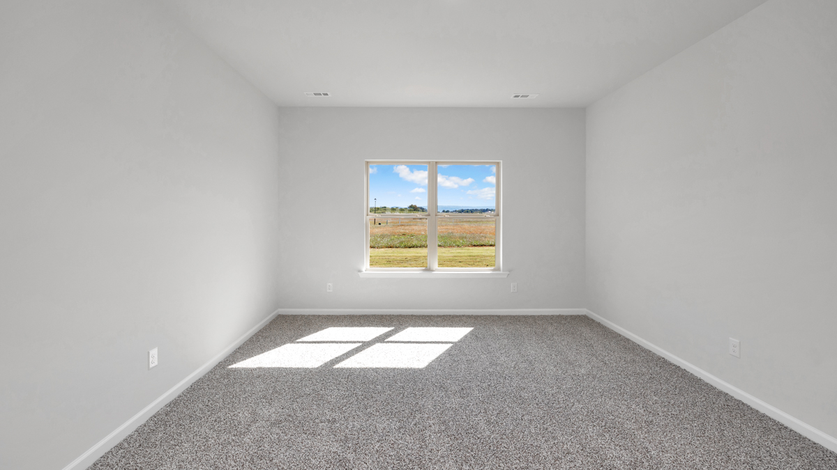 Primary bedroom with carpet