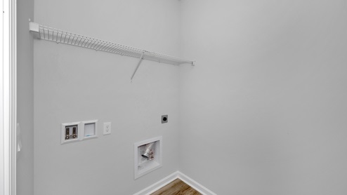Laundry room with wire shelf and washer dryer hook up