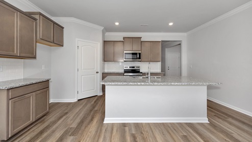 Kitchen island with stained cabinets and stainless steel appliances