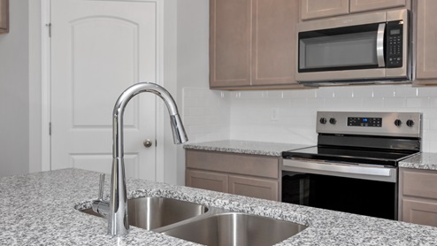 Kitchen sink with granite surround and stainless steel appliances