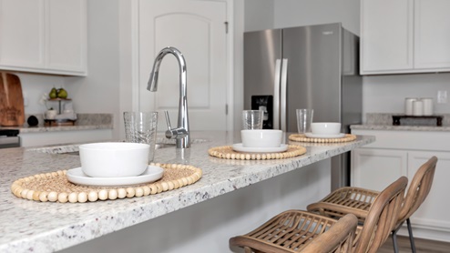 Kitchen sink with granite surround and stainless steel appliances