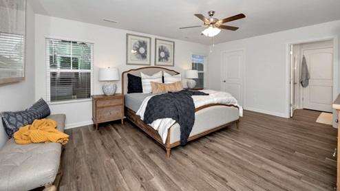 primary bedroom with LVP flooring and window