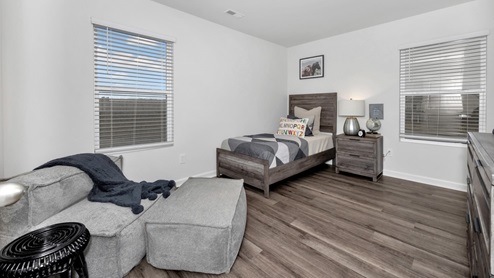 Secondary bedroom with LVP flooring and window