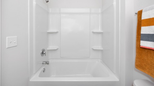 Secondary bathroom with painted cabinets and quartz countertops