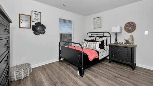 Secondary bedroom with LVP flooring and window