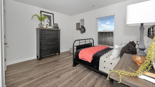 Secondary bedroom with LVP flooring and window