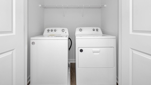 Laundry room with wire shelf and washer dryer hook up