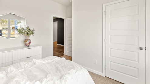 Secondary bedroom with carpet and window
