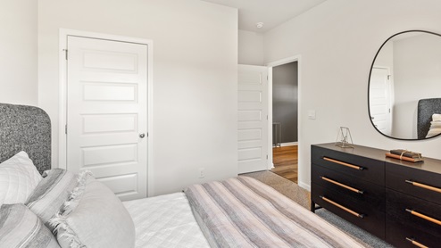Secondary bedroom with carpet and window