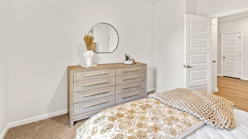 Secondary bedroom with carpet and window