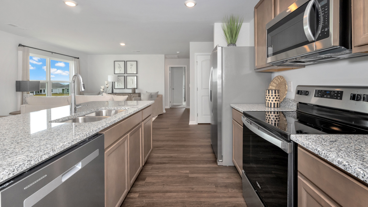 Kitchen island with stained cabinets and stainless steel appliances