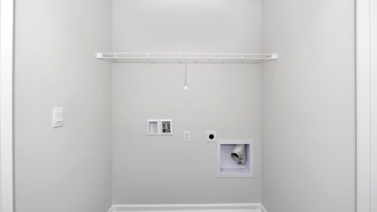 Laundry room with wire shelf and washer dryer hook up