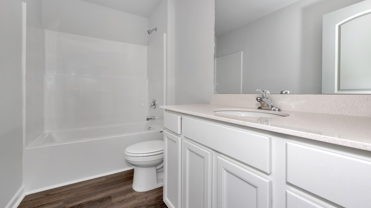 Secondary bathroom with painted cabinets and quartz countertops