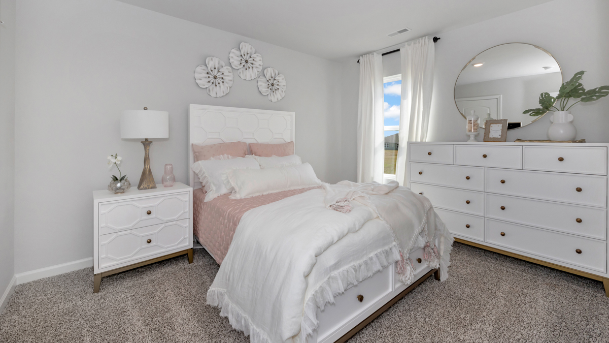 Secondary bedroom with carpet and window