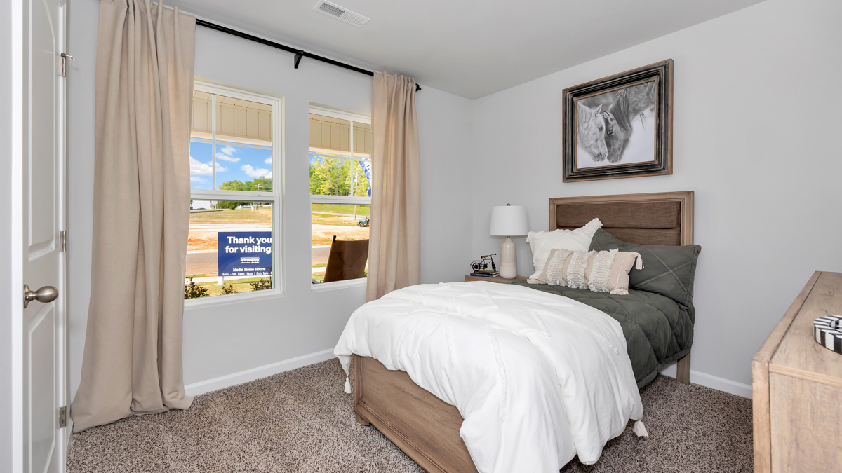 Secondary bedroom with carpet and window