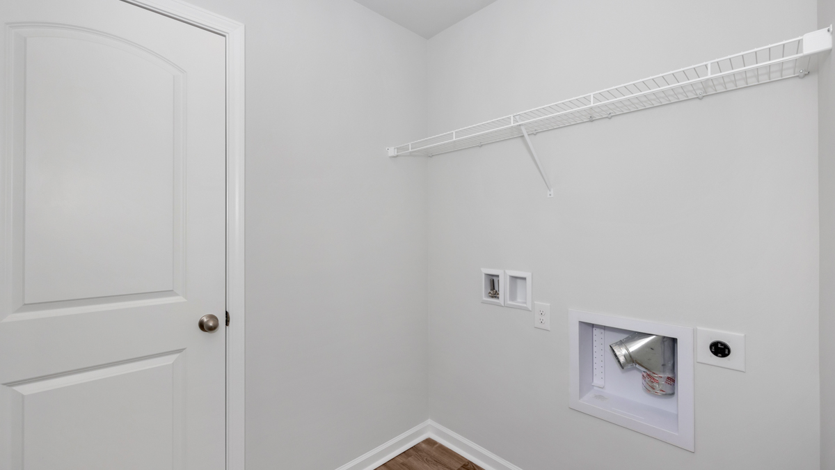 Laundry room with wire shelf and washer dryer hook up