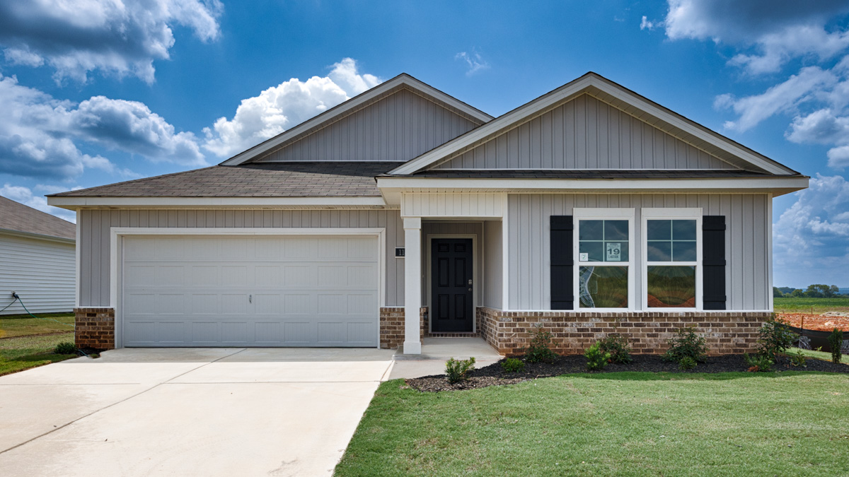 Single story home with vinyl and brick and two car garage