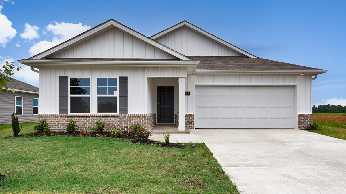 Single story home with vinyl and brick and two car garage