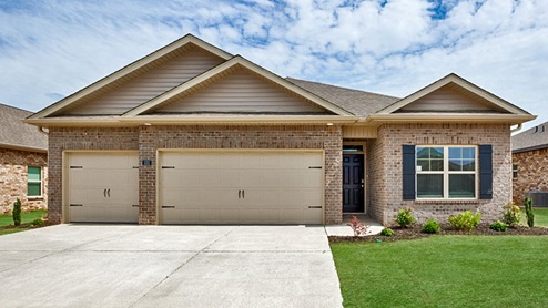 Single story home with brick and three car garage