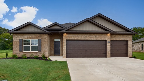 Single story home with brick and three car garage
