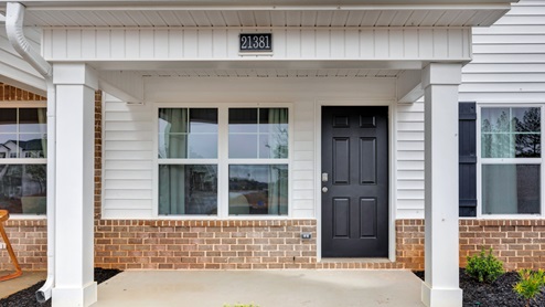 Covered porch with brick, vinyl and columns