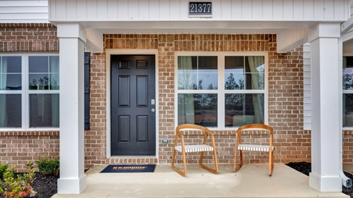 Covered porch with brick, vinyl and columns