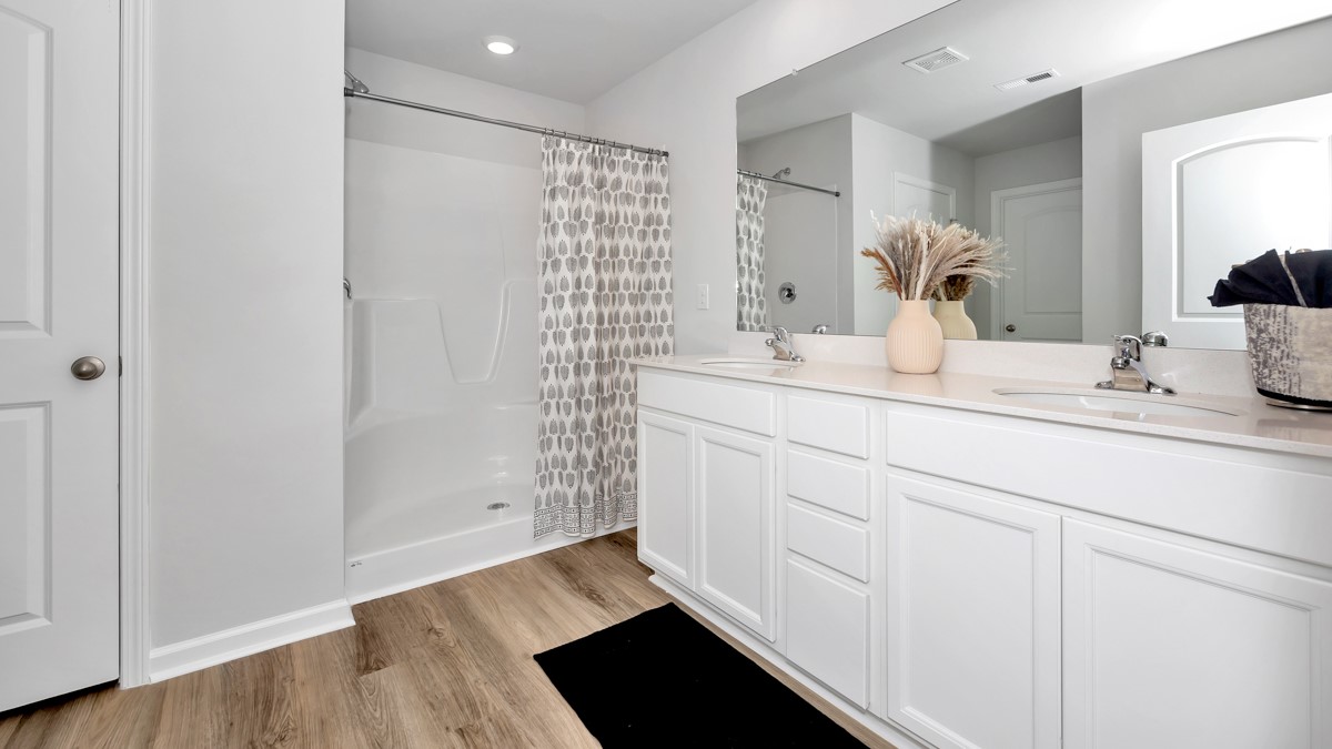 Primary bath with painted cabinets and quartz countertops