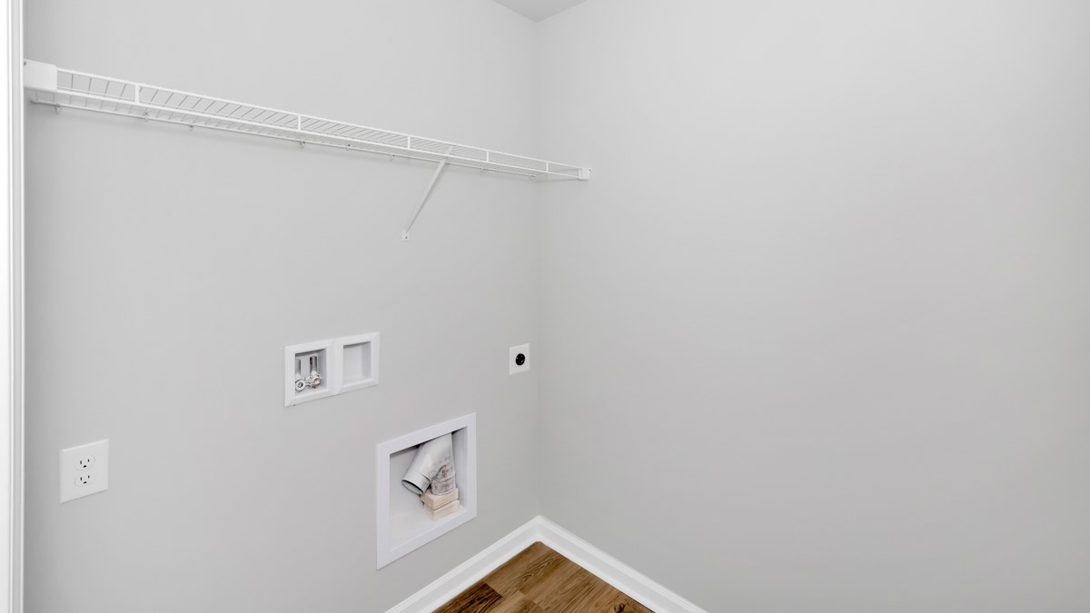 Laundry room with wire shelf and washer dryer hook up