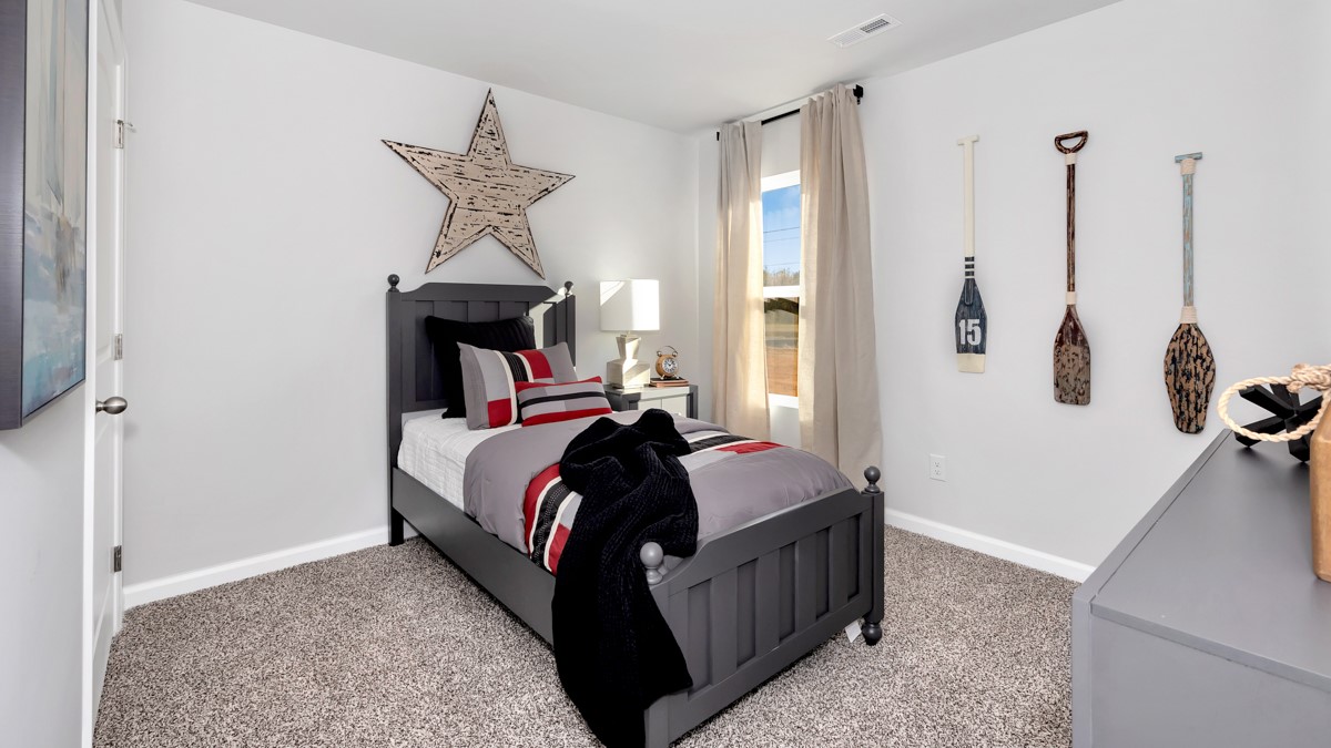 Secondary bedroom with carpet and window